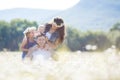 Happy family on a field of blooming daisies Royalty Free Stock Photo