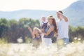 Happy family on a field of blooming daisies Royalty Free Stock Photo