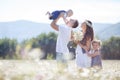 Happy family on a field of blooming daisies Royalty Free Stock Photo