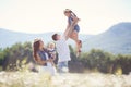 Happy family on a field of blooming daisies Royalty Free Stock Photo