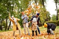 Happy Family of Five Have Fun in Autumn Golden Park, throwing leaves and laughing. Leisure Time Spending Outdoor Royalty Free Stock Photo