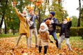 Happy Family of Five Have Fun in Autumn Golden Park, throwing leaves and laughing. Leisure Time Spending Outdoor Royalty Free Stock Photo