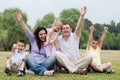 Happy family of five having fun by raising hands Royalty Free Stock Photo