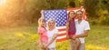 happy family with the flag of america USA at sunset outdoors Royalty Free Stock Photo