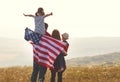 Happy family with flag of america USA at sunset outdoors Royalty Free Stock Photo