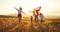 Happy family with flag of america USA at sunset outdoors Royalty Free Stock Photo