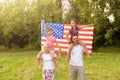 happy family with the flag of america USA at sunset outdoors Royalty Free Stock Photo