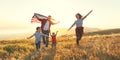 Happy family with flag of america USA at sunset outdoors Royalty Free Stock Photo