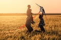 Happy family flying kite in the field at sunset Royalty Free Stock Photo