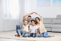 Happy family forming house roof with their hands. Insurance concept Royalty Free Stock Photo