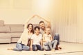 Happy family forming house roof with their hands at home. Insurance concept Royalty Free Stock Photo