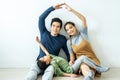 Happy family forming house roof with their hands at home. mother father and children in a new home concept housing a young family Royalty Free Stock Photo