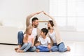 Family forming house roof with their hands at home. Insurance concept Royalty Free Stock Photo