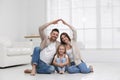 Happy family forming house roof with their hands. Insurance concept Royalty Free Stock Photo