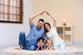 Happy family forming house roof with their hands. Insurance concept Royalty Free Stock Photo