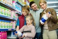 Happy family of four buying pasteurized milk Royalty Free Stock Photo