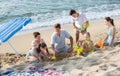 Happy family with four children playing on beach Royalty Free Stock Photo