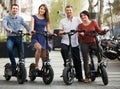 Happy family of four with electrkc bikes