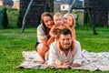 Happy family of four enjoying together resting on a blanket at summer Royalty Free Stock Photo