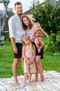 Happy family of four enjoying together resting on blanket at summer Royalty Free Stock Photo