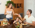 Happy family of four having lunch