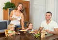 Happy family of four having lunch