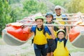 Happy family of four in helmet and live vest ready for rafting on the catamaran Royalty Free Stock Photo