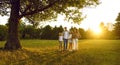 Happy family of four with kids walking in summer park enjoying beautiful nature. Royalty Free Stock Photo