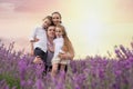 Happy family of four in lavender field