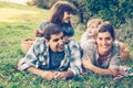 Happy family of four lying in the grass in autumn Royalty Free Stock Photo