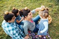 Happy family of four lying in the grass playing with apples in a Royalty Free Stock Photo