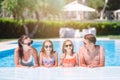 Happy family of four in outdoors swimming pool Royalty Free Stock Photo