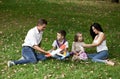 Happy family of four, resting in the autumn park Royalty Free Stock Photo