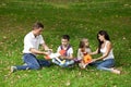 Happy family of four, resting in the autumn park Royalty Free Stock Photo