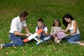 Happy family of four, resting in the autumn park Royalty Free Stock Photo