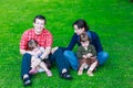 happy family of four sitting on grass Royalty Free Stock Photo