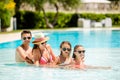 Happy family of four in swimming pool Royalty Free Stock Photo