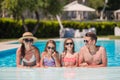 Happy family of four in swimming pool Royalty Free Stock Photo