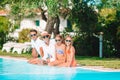 Happy family of four in swimming pool Royalty Free Stock Photo