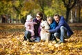 Happy family of four on walk with samoyed dog in park Royalty Free Stock Photo