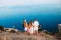 Happy family of four walking in the mountains on the sunset Royalty Free Stock Photo