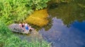 Happy family and friends fishing together outdoors near lake in summer, aerial top view