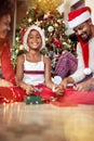 Happy family in front of decorated Christmas tree Royalty Free Stock Photo