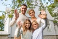 Happy family in front of house outdoors Royalty Free Stock Photo