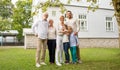 Happy family in front of house outdoors Royalty Free Stock Photo