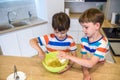 Happy family funny kids are preparing the dough, bake cookies in the kitchen Royalty Free Stock Photo