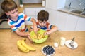 Happy family funny kids are preparing the dough, bake cookies in the kitchen Royalty Free Stock Photo