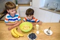 Happy family funny kids are preparing the dough, bake cookies in the kitchen Royalty Free Stock Photo