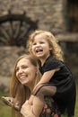 Happy family. Girl child smile on woman shoulders