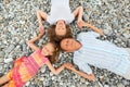 Happy family with girl lying on beach, closed eyes Royalty Free Stock Photo